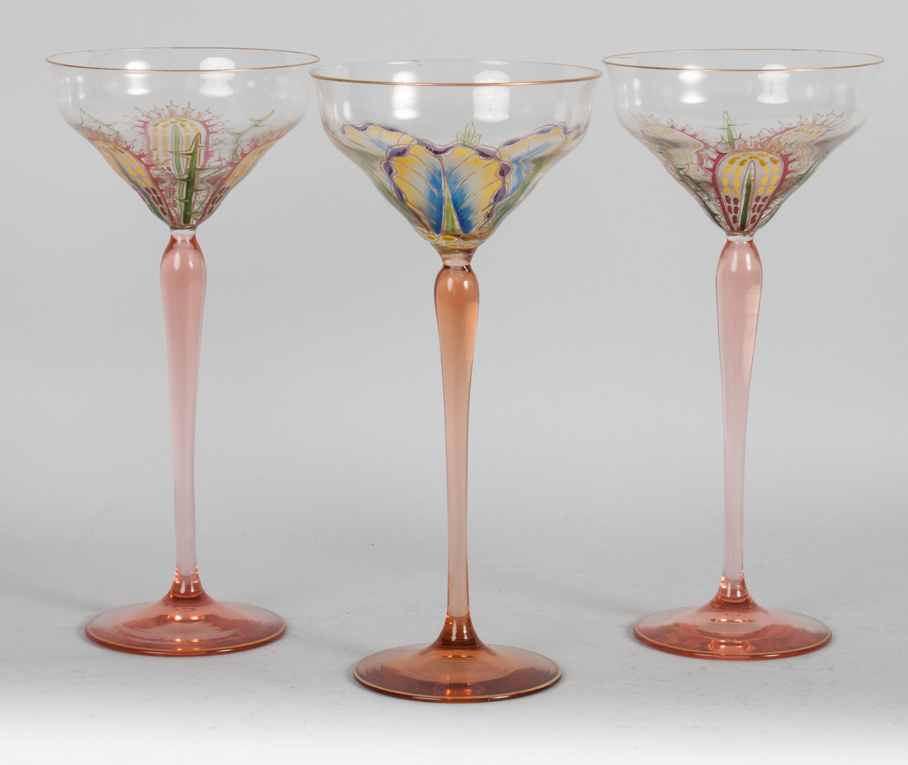 Appraisal: Three Austrian enamel decorated wine stems each with pink stem