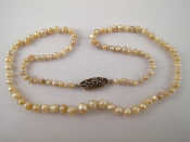 Appraisal: A graduated natural pearl necklace approx cm long accompanied by