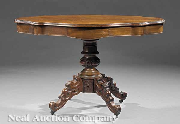 Appraisal: A Victorian Carved Mahogany Center Table th c serpentine top