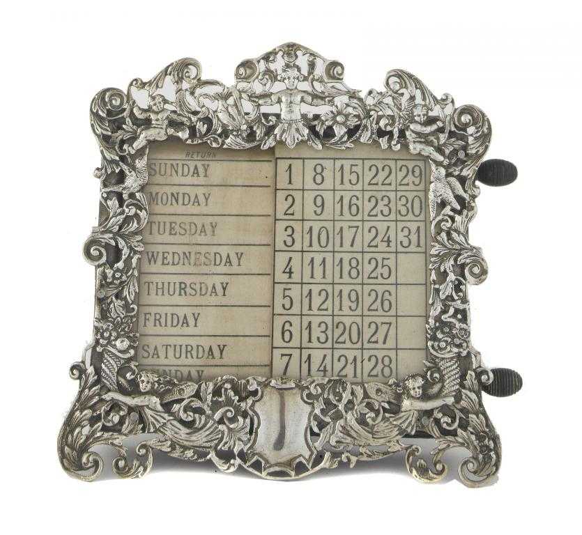 Appraisal: A VICTORIAN CALENDAR the ornate openwork frame with demi figures