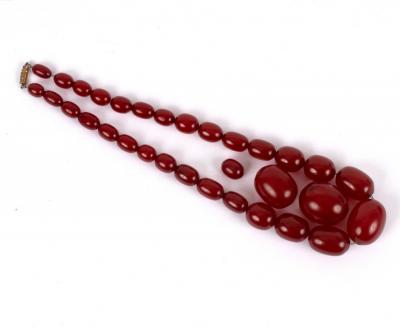 Appraisal: A single row of graduated cherry amber beads and two