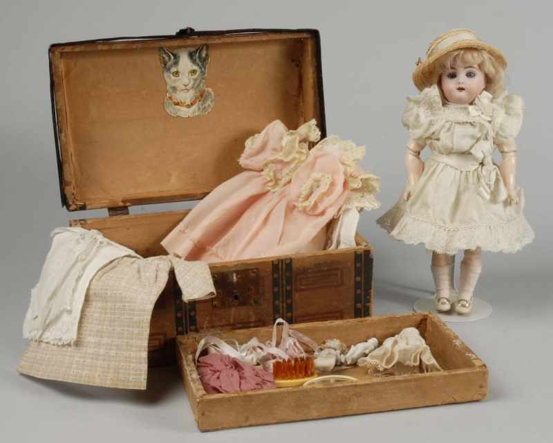 Appraisal: Bisque Kammer Reinhardt Doll with Wardrobe Description Mold bisque socket