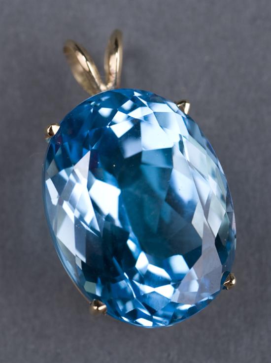 Appraisal: kt yellow gold blue tropaz pendant Containing one oval swiss