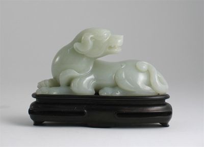 Appraisal: A Chinese pale celadon jade carving of a recumbent hound