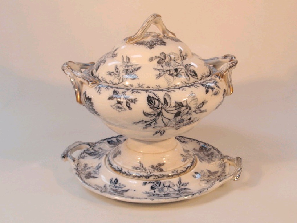 Appraisal: A Victorian pottery soup tureen cover and stand printed in