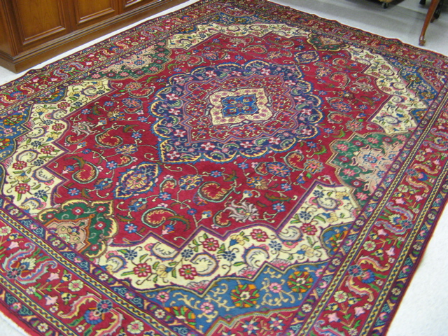 Appraisal: PERSIAN TABRIZ CARPET floral and central floral medallion design on