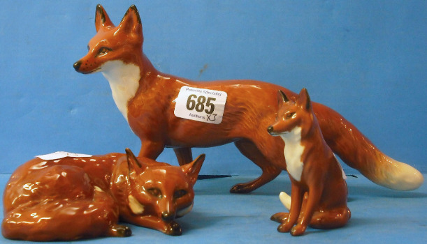 Appraisal: Beswick Foxes large Standing Curled and Seated