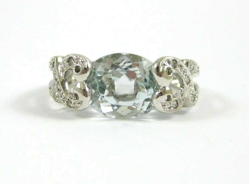 Appraisal: AQUAMARINE DIAMOND AND FOURTEEN KARAT GOLD RING with round-cut diamonds