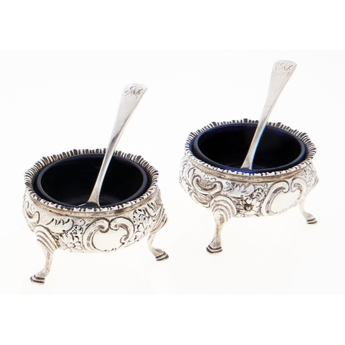 Appraisal: A pair of Victorian silver salt cellars chased with flowers