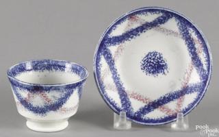 Appraisal: Miniature blue and purple rainbow spatter cup and saucer Provenance