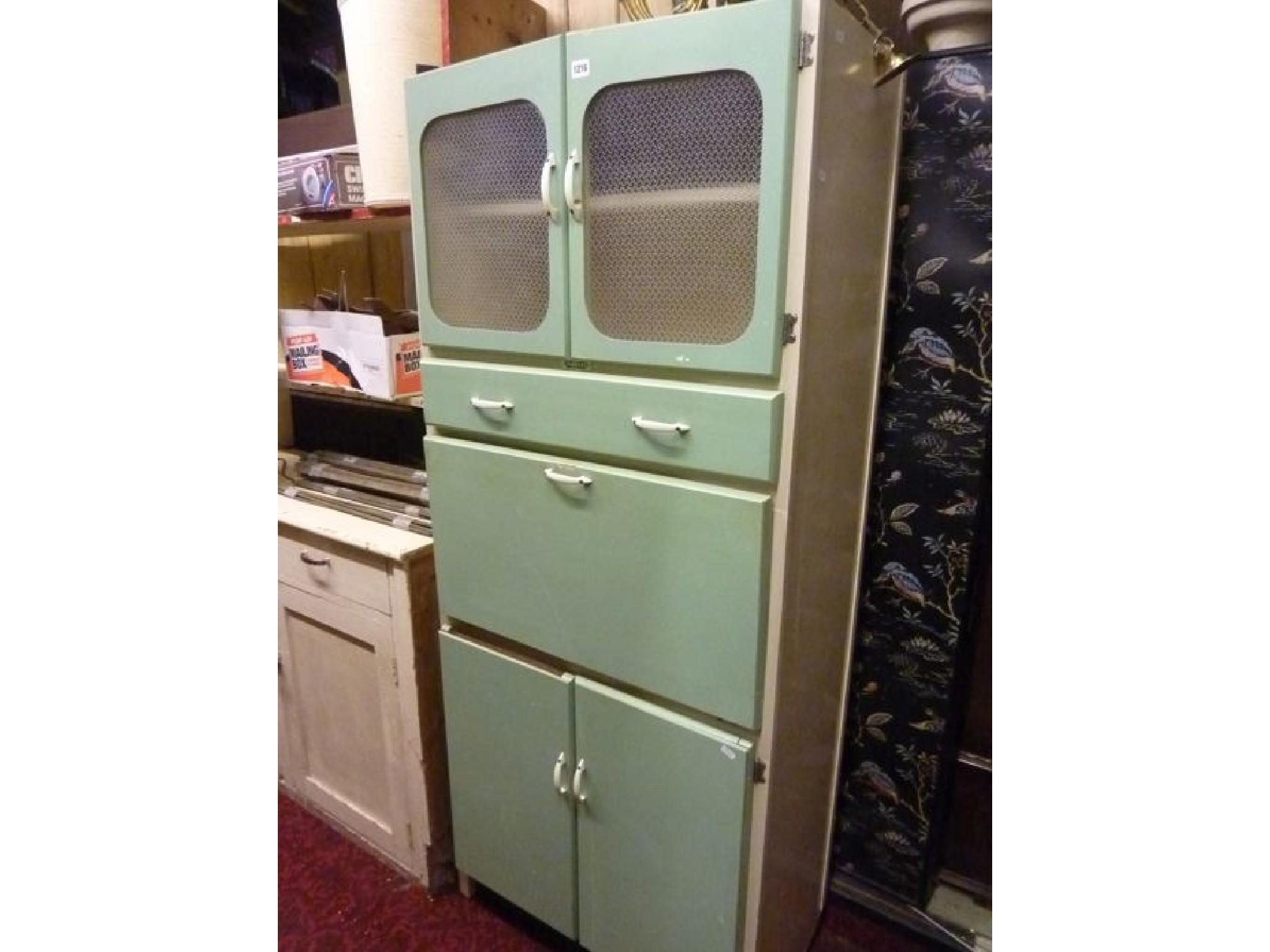 Appraisal: A vintage freestanding kitchen cabinet enclosed by an arrangement of