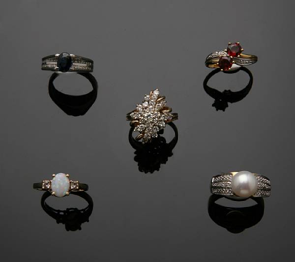 Appraisal: A collection of seven gem-set diamond and gold rings featuring