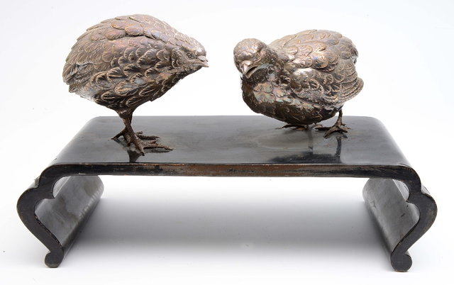 Appraisal: A pair of Japanese silver models of quailslate Meiji period