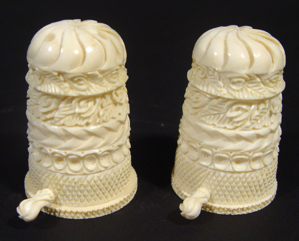 Appraisal: Two heavily carved bone salt and pepper pots with detatchable