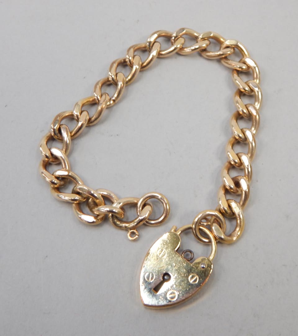 Appraisal: A gold plated gate bracelet with padlock