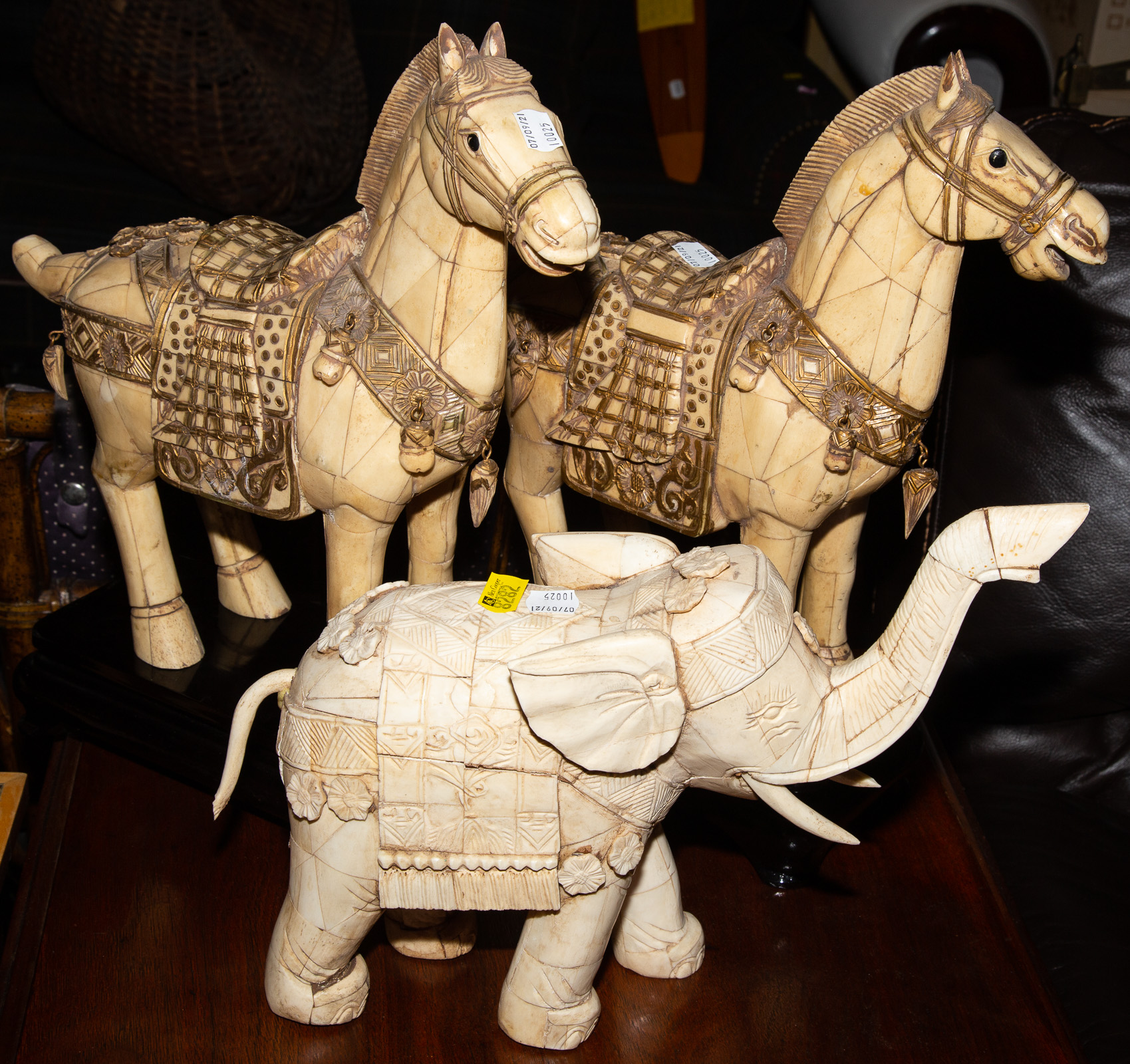 Appraisal: THREE CHINESE CARVED BONE ANIMALS Includes a pair of horse