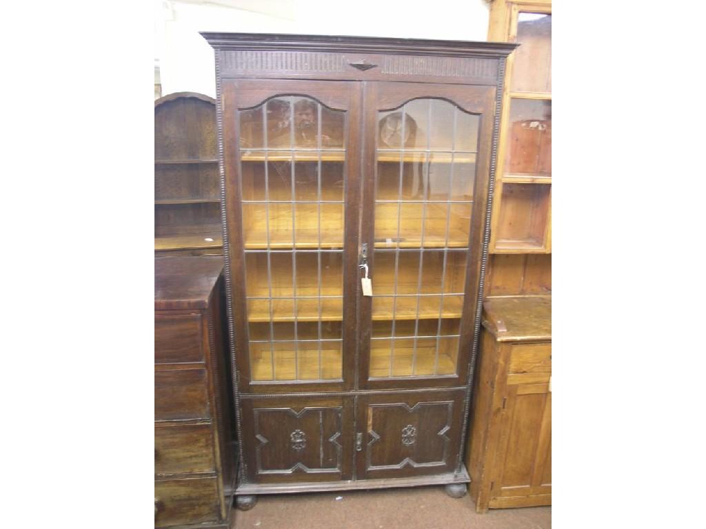 Appraisal: A 's solid dark oak bookcase pair of leaded glazed