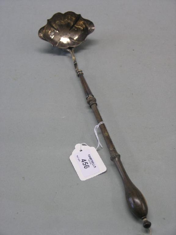 Appraisal: A George III silver toddy ladle bowl of scalloped oval