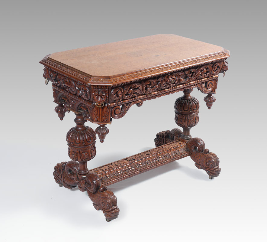 Appraisal: RENAISSANCE REVIVAL CARVED OAK LIBRARY TABLE Rectangular top with canted