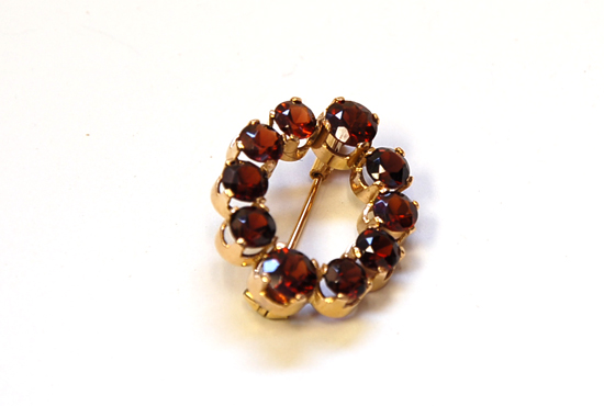 Appraisal: A Gold and Garnet Oval Brooch K tested yellow gold