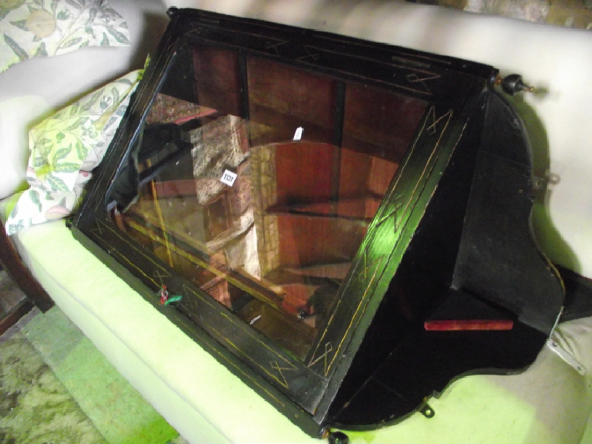 Appraisal: A Victorian ebonised hanging corner cupboard with glazed panelled door