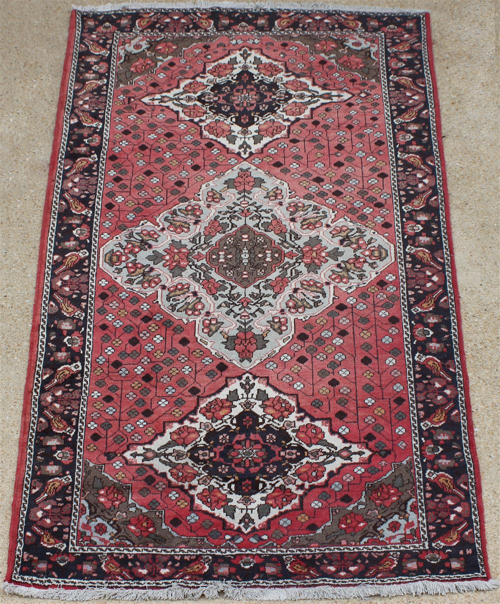 Appraisal: PERSIAN THREE MEDALLION WOOL RUG large central medallion flanked by