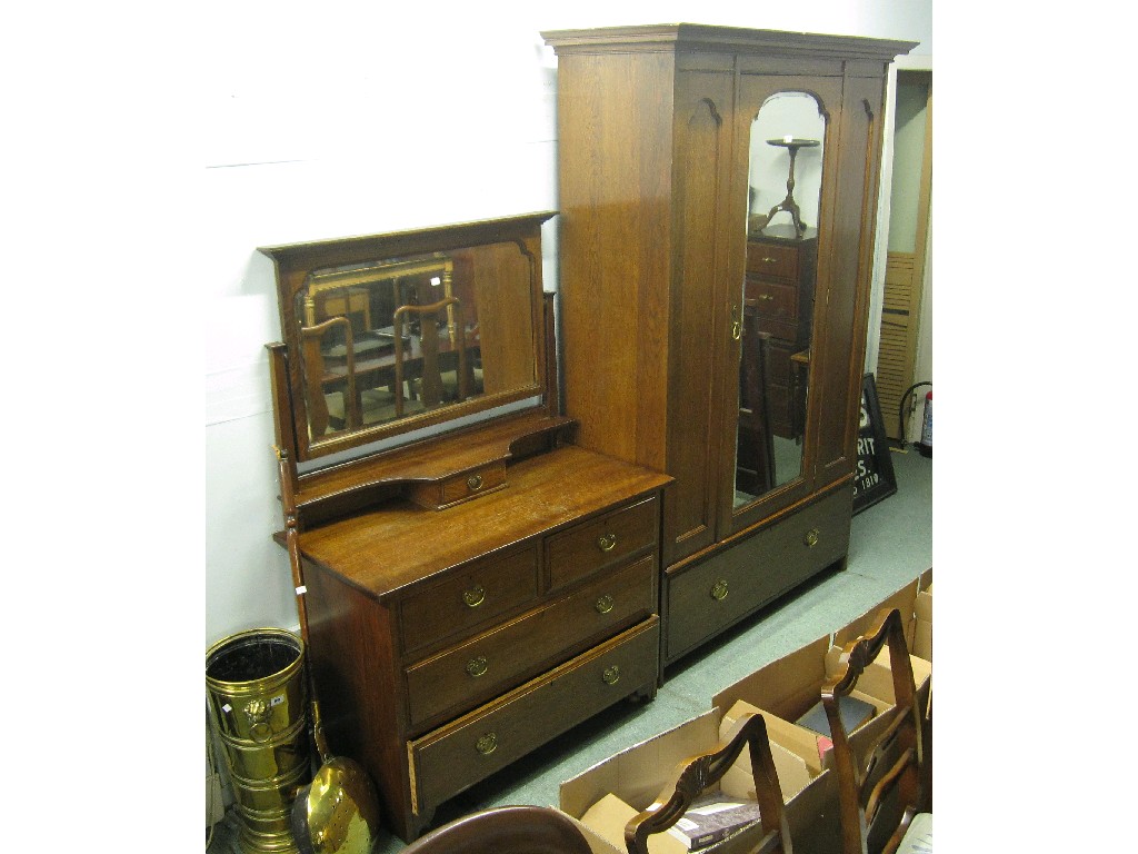 Appraisal: Oak bedroom suite comprising a dressing table and matching wardrobe