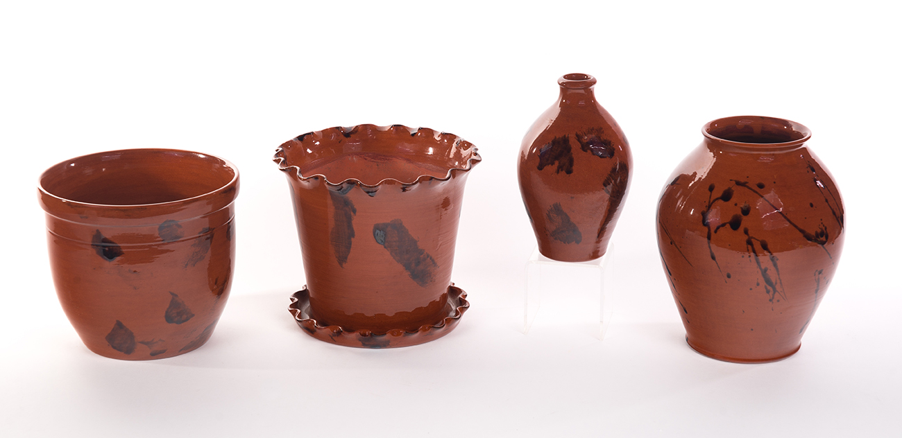 Appraisal: FOUR BRININGER REDWARE VESSELS WITH BROWN GLAZE DECORATION American late