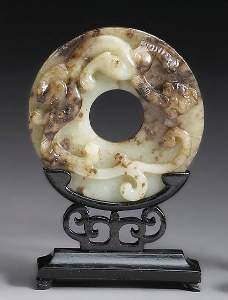 Appraisal: A carved nephrite bi The thinly sectioned disk centered with