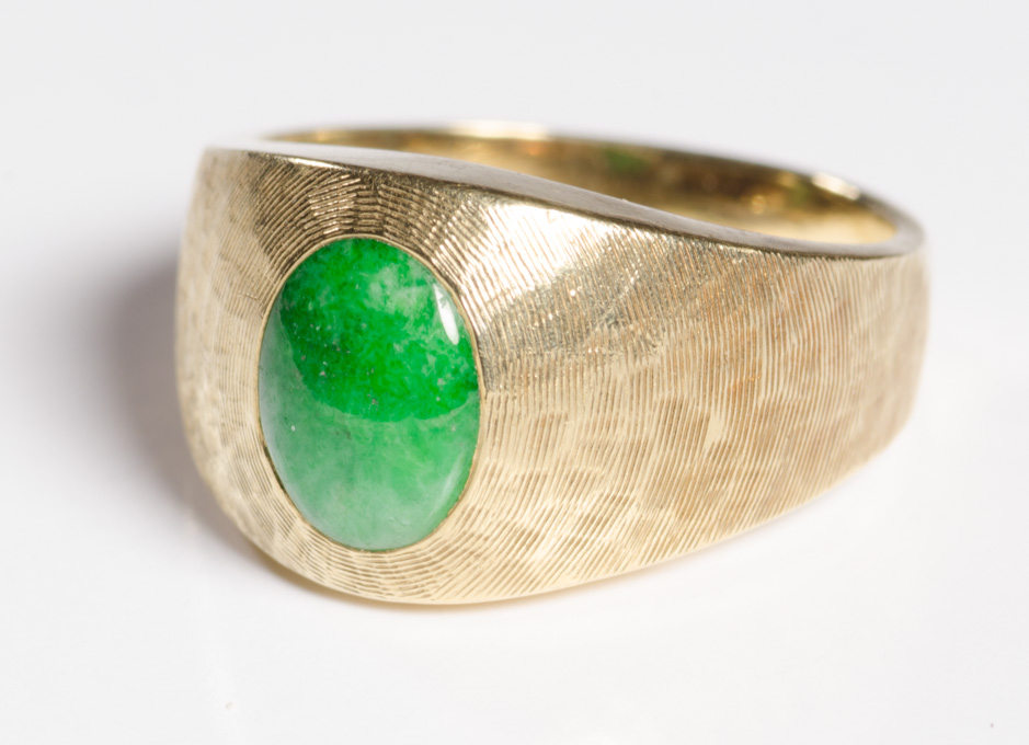 Appraisal: JADE AND FOURTEEN KARAT GOLD RING set with an oval