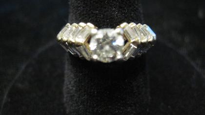 Appraisal: karat yellow gold and diamond ringCentral round cut diamond approximately