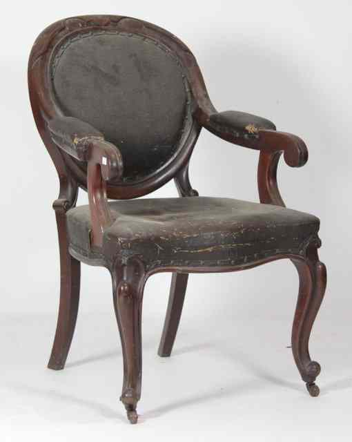 Appraisal: A Victorian open armchair the arch back above padded scroll