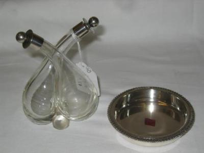 Appraisal: AN EDWARDIAN GLASS VINEGAR BOTTLE of double spouted form with