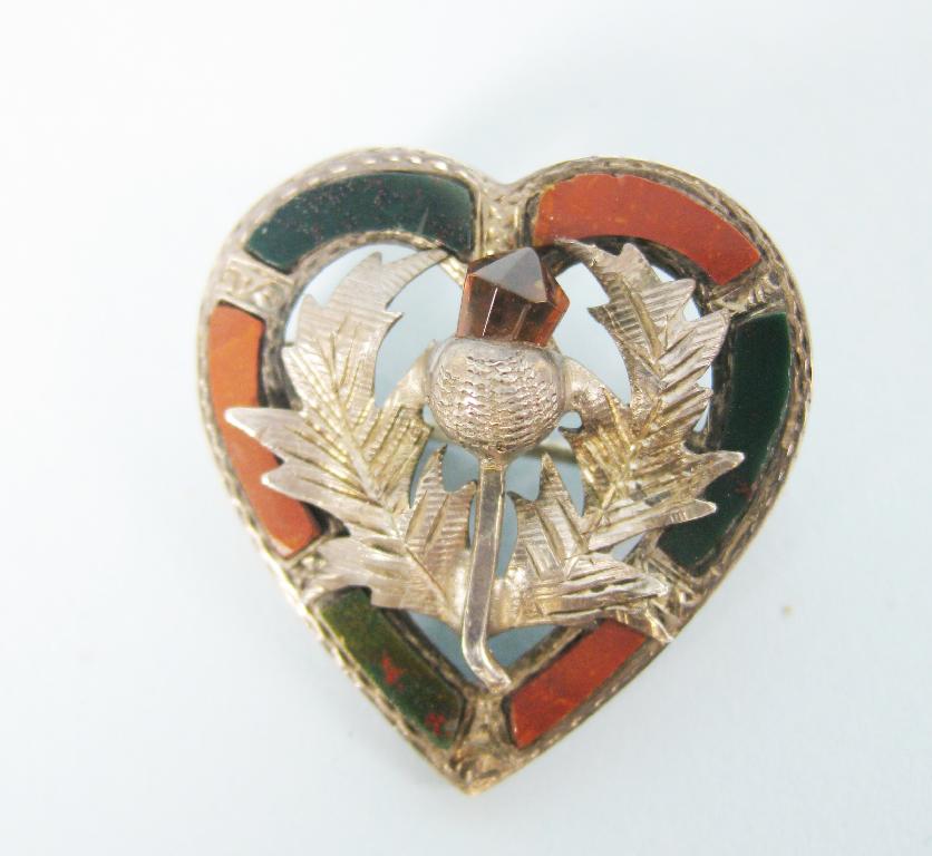 Appraisal: A Scottish pebble heart-shape silver Brooch with central thistle and