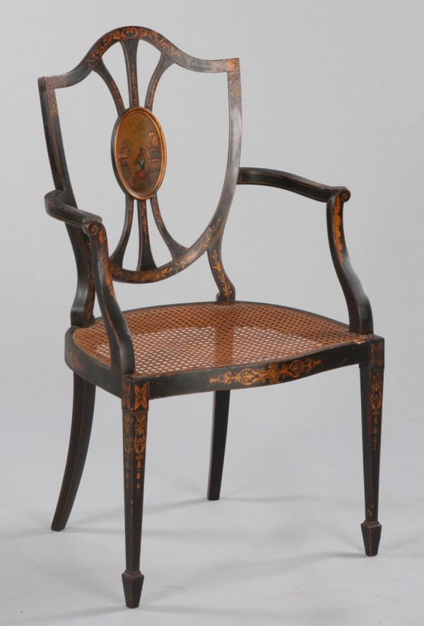 Appraisal: Ebonized shield back open armchair figural decorated medallion cane seat