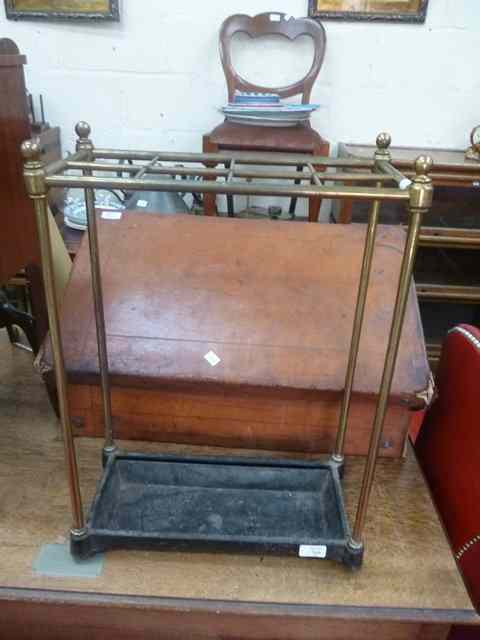 Appraisal: A BRASS AND CAST IRON STICK STAND wide together with