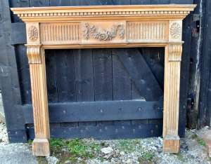 Appraisal: A pine fire surround decorated with carved floral motif