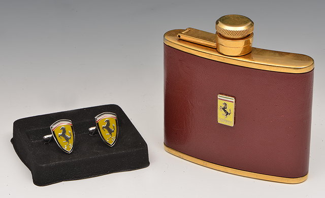 Appraisal: FERRARI A GOLD-PLATED OZ STAINLESS-STEEL BRANDY FLASK with deep red