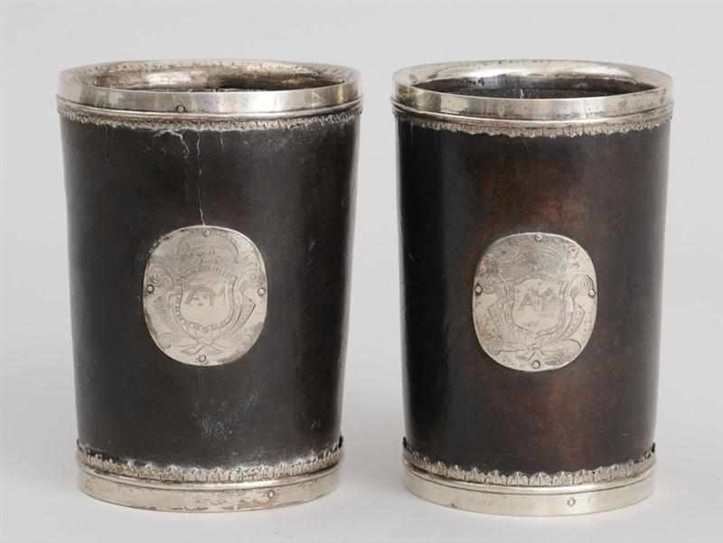 Appraisal: PAIR OF SILVER-MOUNTED LEATHER CUPS Each applied with leaf-tip edges