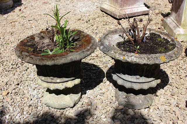 Appraisal: A PAIR OF SMALL CAST CONCRETE GARDEN URNS of flaring