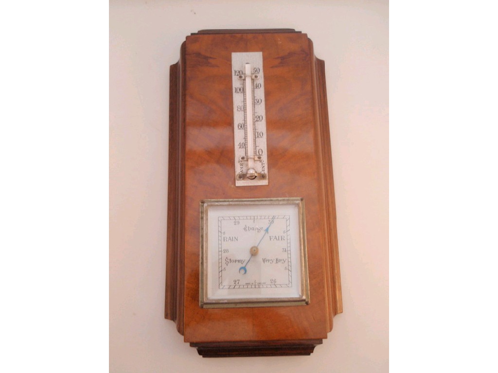 Appraisal: An Odeonesque walnut cased aneroid barometer with mounted thermometer over