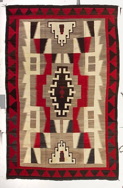 Appraisal: A Navajo rug A central interlaced diamond flanked by serrated