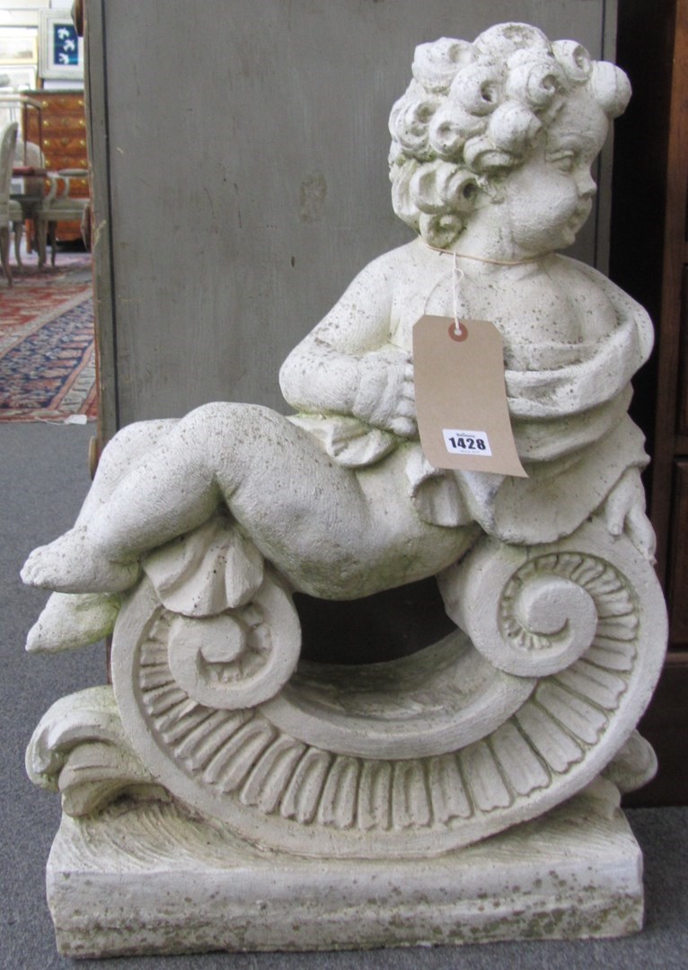 Appraisal: A pair of reconstituted stone figures of cherubs sat on