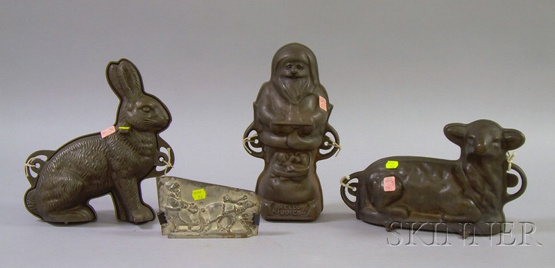 Appraisal: Three Cast Iron Figural Food Molds and a Tin Santa's