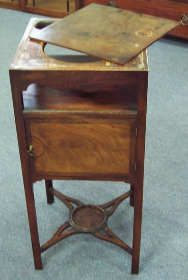 Appraisal: A Regency mahogany bedside cupboard with pierced top enclosed by