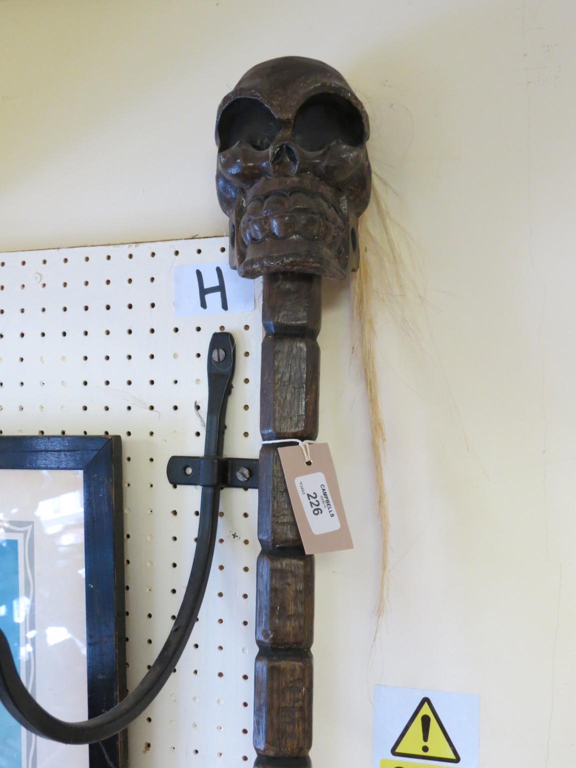 Appraisal: A witch-doctor's carved wood staff with skull terminal ft in