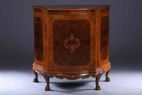 Appraisal: ENGLISH STYLE WALNUT DEMILUNE SIDE CABINET th century Shaped molded-edge