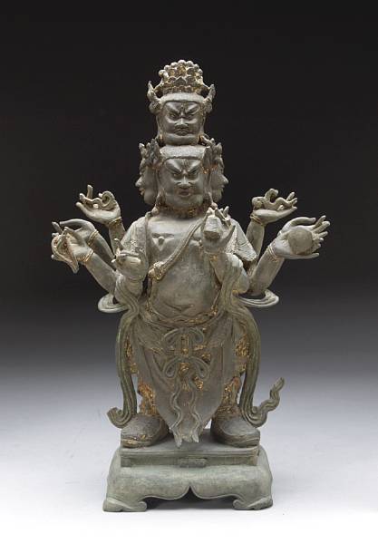 Appraisal: A cast bronze standing figure of a guardian deity th