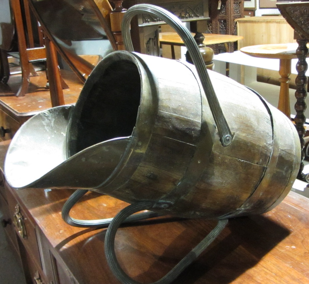 Appraisal: A coopered ash coal bucket with reeded brass swing handle