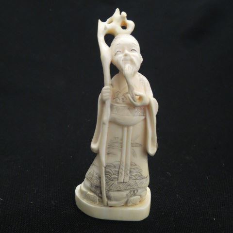 Appraisal: Chinese Carved Ivory Figurine of an Immortal a bearded man